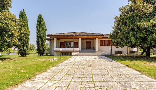 A cozy luxury villa surrounded by greenery, featuring spacious, breathtaking terraces