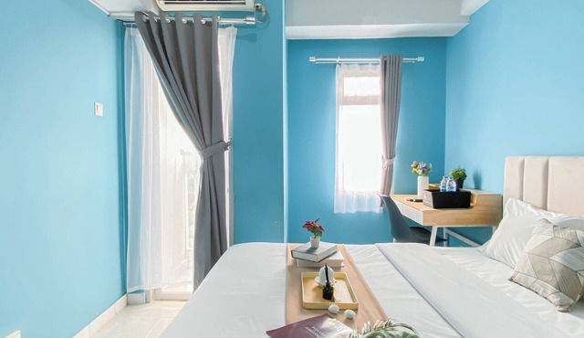 Neat Studio With Blue Toned Wall At Dramaga Tower Apartment